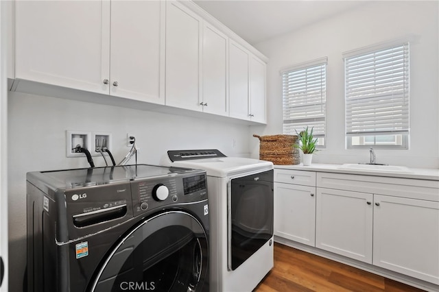 1711 Sonora Creek Ln, Lake Forest, CA 92610 - clothes washing area with washer and dryer, wood finished floors, a sink, and cabinet space