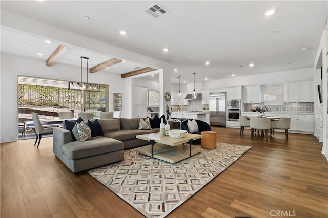 1711 Sonora Creek Ln, Lake Forest, CA 92610 - living room with recessed lighting, beamed ceiling, and wood finished floors