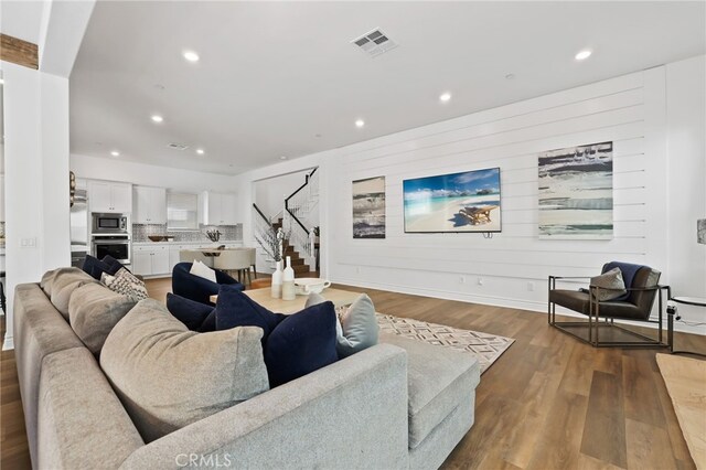 1711 Sonora Creek Ln, Lake Forest, CA 92610 - living area with wood finished floors, recessed lighting, visible vents, and stairs