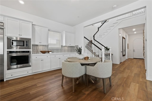 1711 Sonora Creek Ln, Lake Forest, CA 92610 - kitchen with dark wood-type flooring, tasteful backsplash, white cabinets, and stainless steel appliances