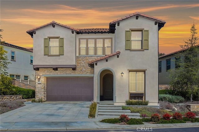 1711 Sonora Creek Ln, Lake Forest, CA 92610 - mediterranean / spanish-style house with a tiled roof, an attached garage, stone siding, and stucco siding