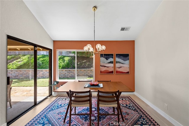 5649 Roane Dr, Oceanside, CA 92057 - dining space with light wood finished floors, a chandelier, and baseboards