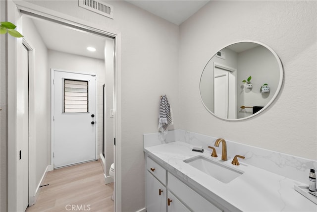 5649 Roane Dr, Oceanside, CA 92057 - full bath featuring wood finished floors, vanity, a shower stall, toilet, and baseboards