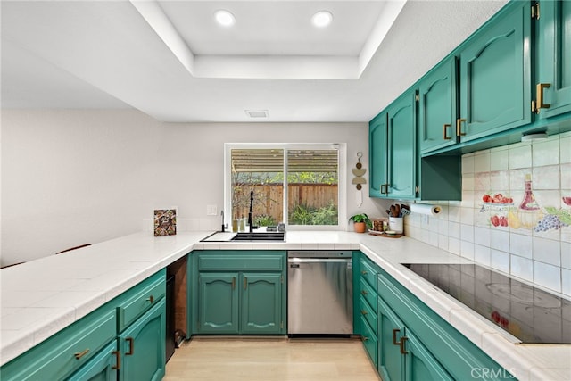 5649 Roane Dr, Oceanside, CA 92057 - kitchen with stainless steel dishwasher, a sink, light wood-style floors, tasteful backsplash, and light countertops