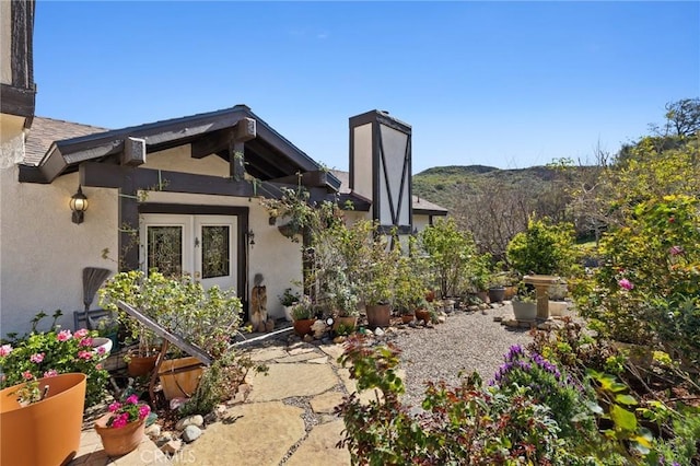 28061 Modjeska Grade, Modjeska Canyon, CA 92676 - view of exterior entry featuring stucco siding and a chimney