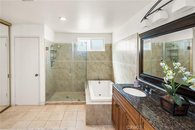 bathroom with tile patterned floors, a garden tub, vanity, and a shower stall