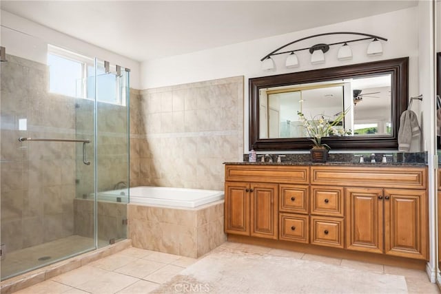 bathroom featuring a sink, a stall shower, a bath, double vanity, and tile patterned flooring