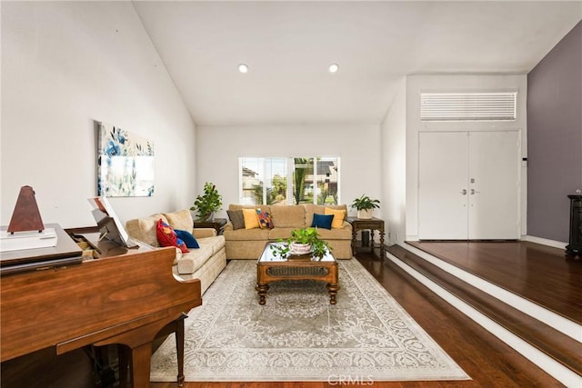 living area with baseboards, vaulted ceiling, wood finished floors, and recessed lighting