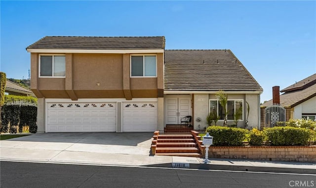 11818 Pocasset Dr, Whittier, CA 90601 - view of front of home with stucco siding, a garage, concrete driveway, and a tile roof