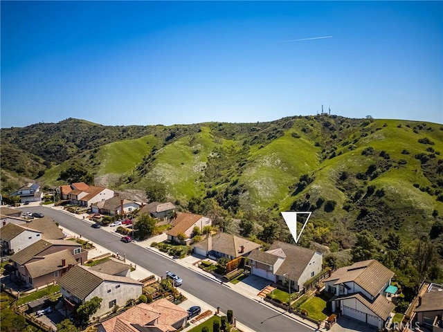 drone / aerial view featuring a residential view and a mountain view
