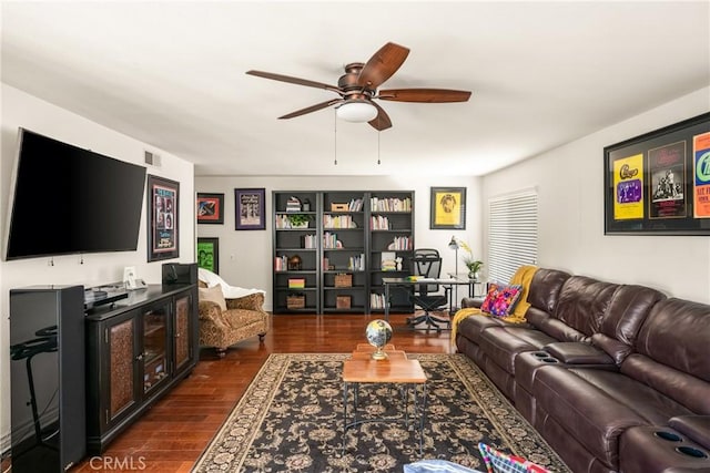 living area featuring visible vents, ceiling fan, and dark wood-style flooring