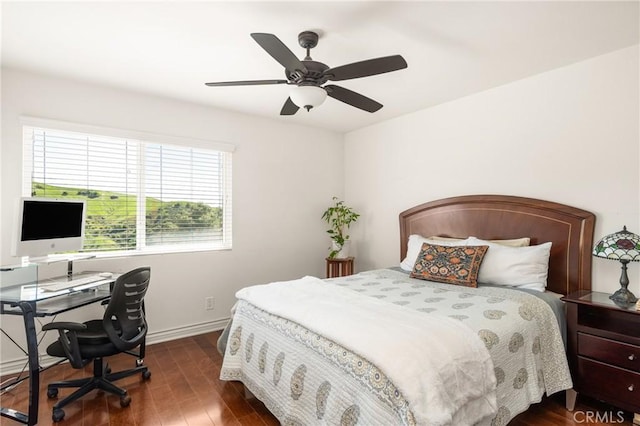 bedroom with baseboards, ceiling fan, and dark wood-style flooring