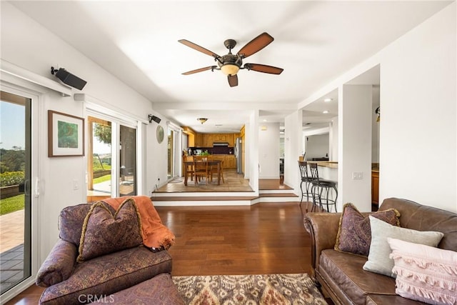 living room with ceiling fan and wood finished floors