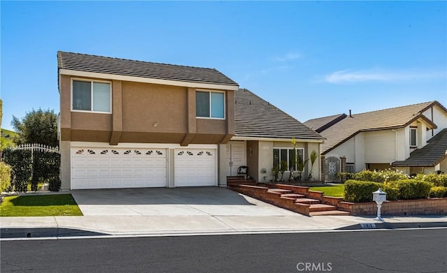 traditional-style home with a garage, concrete driveway, a tiled roof, and stucco siding