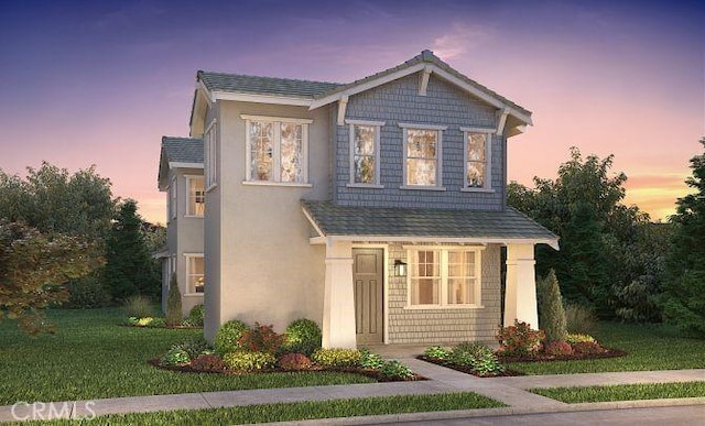 view of front of house with a front yard and stucco siding