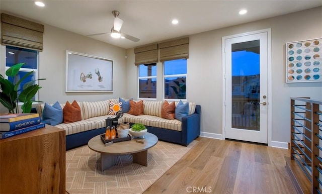 living area with recessed lighting, baseboards, light wood-type flooring, and a ceiling fan