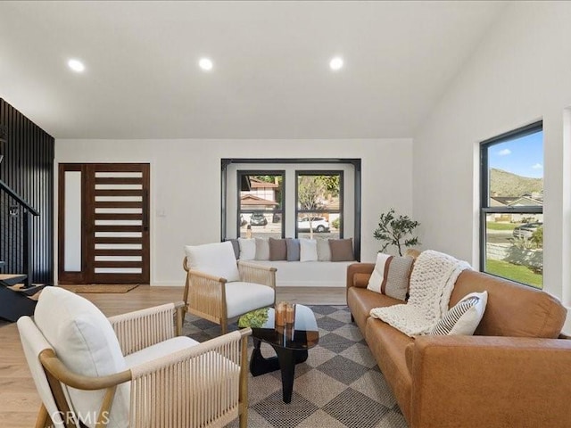 living room featuring lofted ceiling, recessed lighting, and wood finished floors