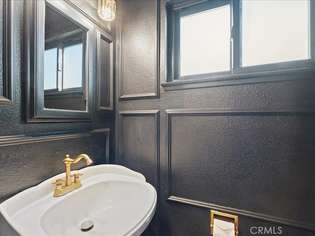 bathroom with a sink and a textured wall