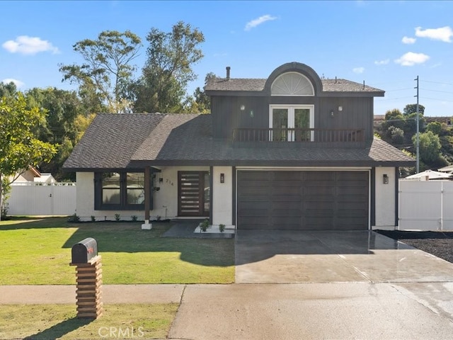 view of front facade with a gate, fence, driveway, stucco siding, and a front lawn