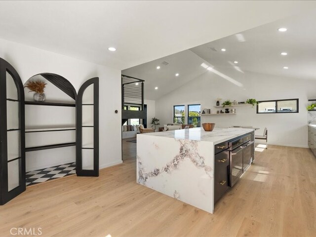 214 Maynard Ave, Newbury Park, CA 91320 - kitchen featuring light wood finished floors, lofted ceiling, a center island, black oven, and recessed lighting