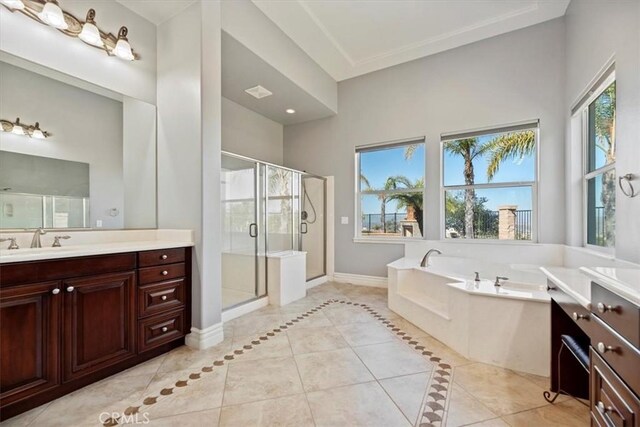 4195 Robby Cir, Corona, CA 92881 - full bath featuring tile patterned floors, vanity, a garden tub, a stall shower, and baseboards