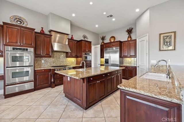 4195 Robby Cir, Corona, CA 92881 - kitchen with appliances with stainless steel finishes, a warming drawer, wall chimney exhaust hood, a sink, and a center island with sink