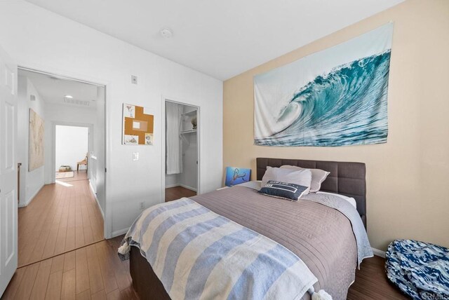 13325 Via Constanza Unit 2, San Diego, CA 92129 - bedroom with hardwood / wood-style flooring and a spacious closet