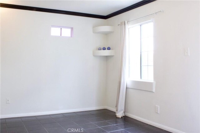 323 E Hanna St, Colton, CA 92324 - spare room featuring crown molding, dark tile patterned flooring, and baseboards