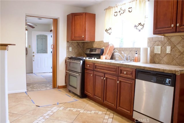 323 E Hanna St, Colton, CA 92324 - kitchen with a sink, stainless steel appliances, backsplash, tile counters, and light tile patterned floors