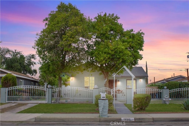 323 E Hanna St, Colton, CA 92324 - view of front of property featuring a fenced front yard, stucco siding, and a gate