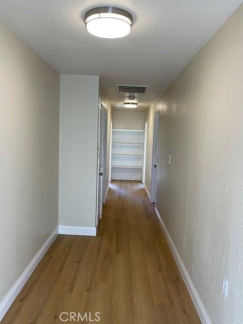 9286 San Benito Ave, Gerber, CA 96035 - corridor featuring light wood-style flooring, baseboards, and visible vents
