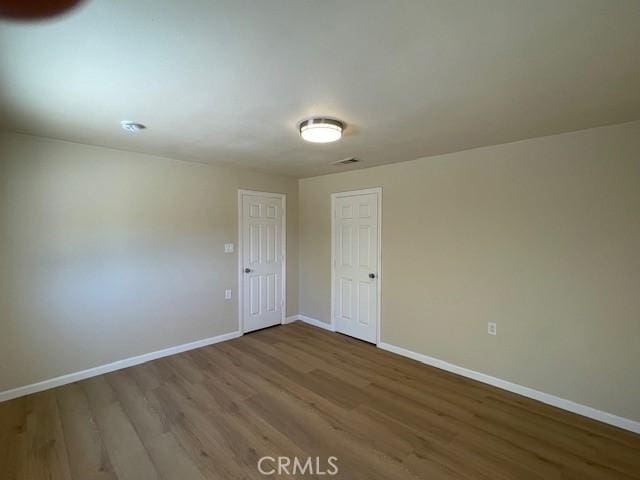 9286 San Benito Ave, Gerber, CA 96035 - unfurnished room featuring visible vents, wood finished floors, and baseboards