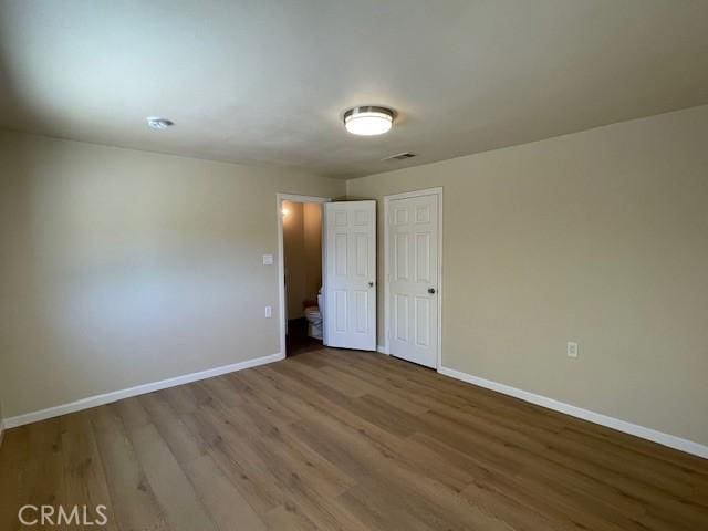 9286 San Benito Ave, Gerber, CA 96035 - unfurnished bedroom featuring visible vents, baseboards, and wood finished floors