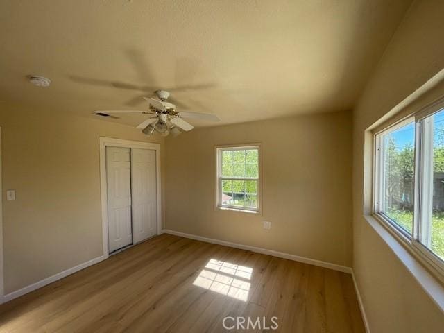 9286 San Benito Ave, Gerber, CA 96035 - unfurnished bedroom featuring visible vents, baseboards, light wood-style flooring, a closet, and a ceiling fan