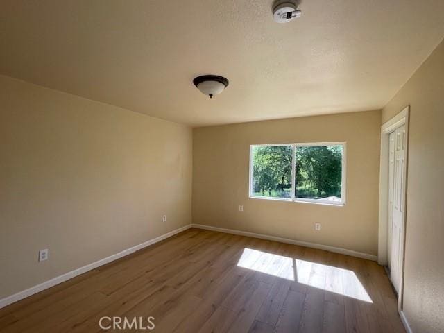 9286 San Benito Ave, Gerber, CA 96035 - unfurnished bedroom featuring wood finished floors and baseboards
