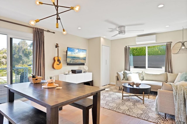 dining room featuring recessed lighting, wood finished floors, a healthy amount of sunlight, and a wall unit AC