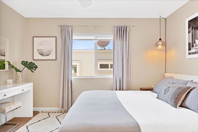 bedroom with baseboards and wood finished floors