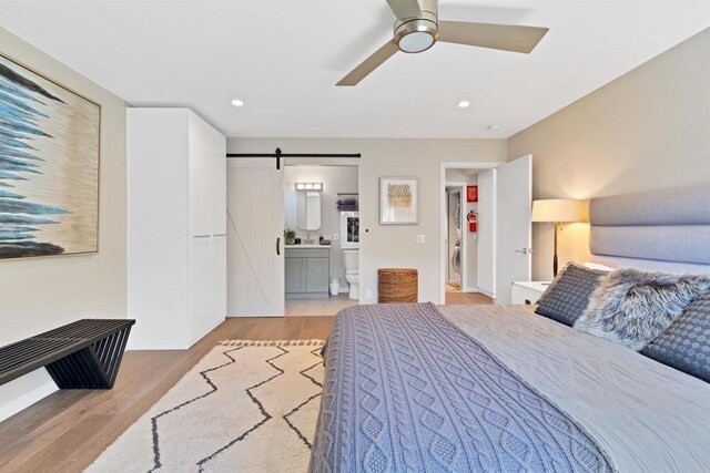 1631 Neptune Ave, Encinitas, CA 92024 - bedroom with light wood finished floors, a barn door, connected bathroom, recessed lighting, and a ceiling fan