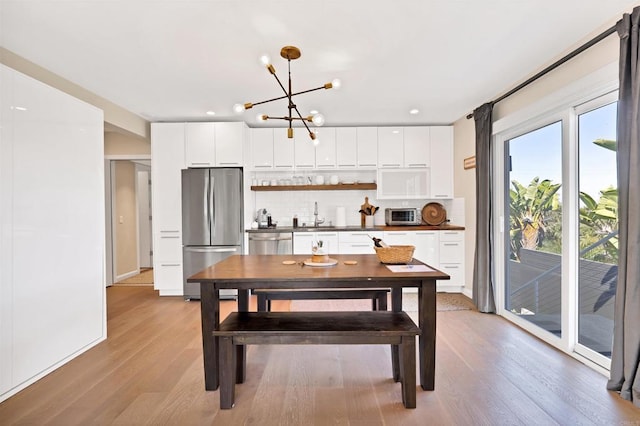 1631 Neptune Ave, Encinitas, CA 92024 - dining area with light wood-style floors, a chandelier, and recessed lighting