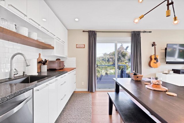1631 Neptune Ave, Encinitas, CA 92024 - kitchen featuring a sink, stainless steel dishwasher, open shelves, light wood-style flooring, and tasteful backsplash