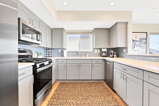 1631 Neptune Ave, Encinitas, CA 92024 - kitchen with appliances with stainless steel finishes, gray cabinetry, healthy amount of natural light, a sink, and recessed lighting