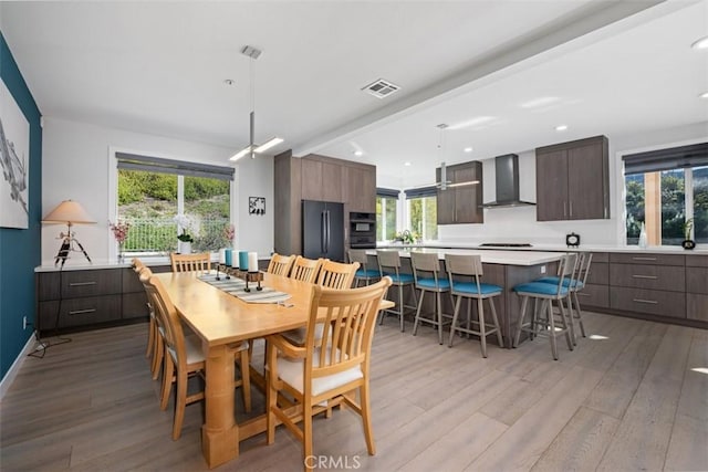 dining room with light wood-type flooring, visible vents, and recessed lighting