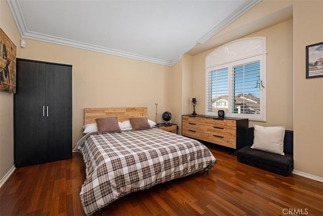 bedroom featuring baseboards, crown molding, and wood finished floors
