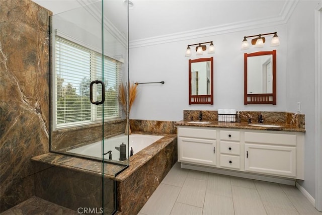 bathroom with crown molding, a garden tub, double vanity, and a sink