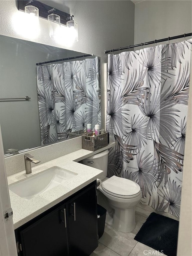 full bath featuring toilet, curtained shower, tile patterned flooring, and vanity