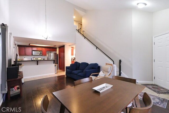 414 N Imperial Ave Unit D, Ontario, CA 91764 - dining room featuring a towering ceiling and dark wood-style floors
