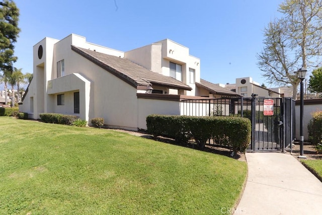414 N Imperial Ave Unit D, Ontario, CA 91764 - view of side of property with stucco siding, a gate, and a tiled roof
