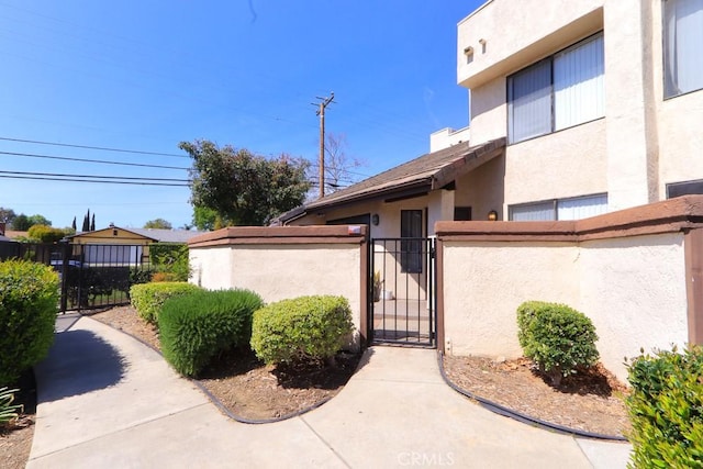 414 N Imperial Ave Unit D, Ontario, CA 91764 - doorway to property with stucco siding and a gate