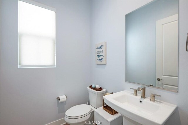 135 Bosal, Irvine, CA 92618 - half bathroom featuring toilet, a sink, and baseboards