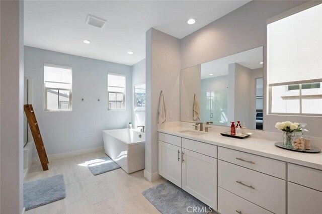 135 Bosal, Irvine, CA 92618 - full bath featuring a freestanding bath, vanity, a shower, recessed lighting, and baseboards